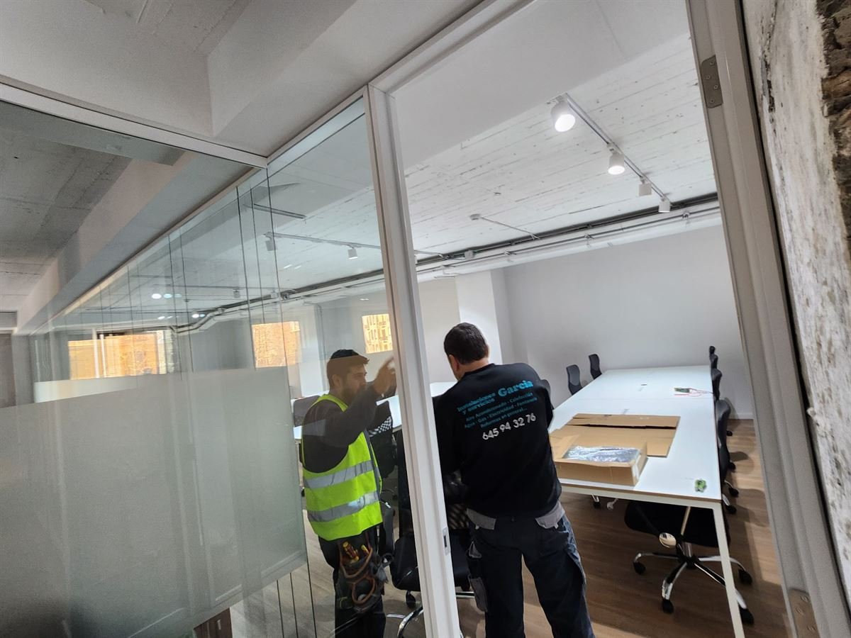 Montaje de la instalación en una de las salas acristaladas, con los puestos de trabajo ya colocados